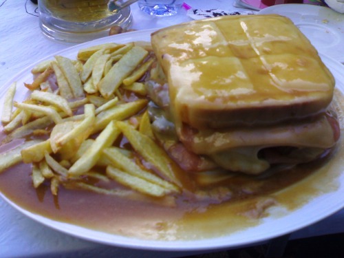 Francesinha
Steak or roast sandwich with wet-cured ham, linguica, and sausage covered with cheese in a hot thick tomato and beer sauce.
(submitted by Patresi via wikipedia)